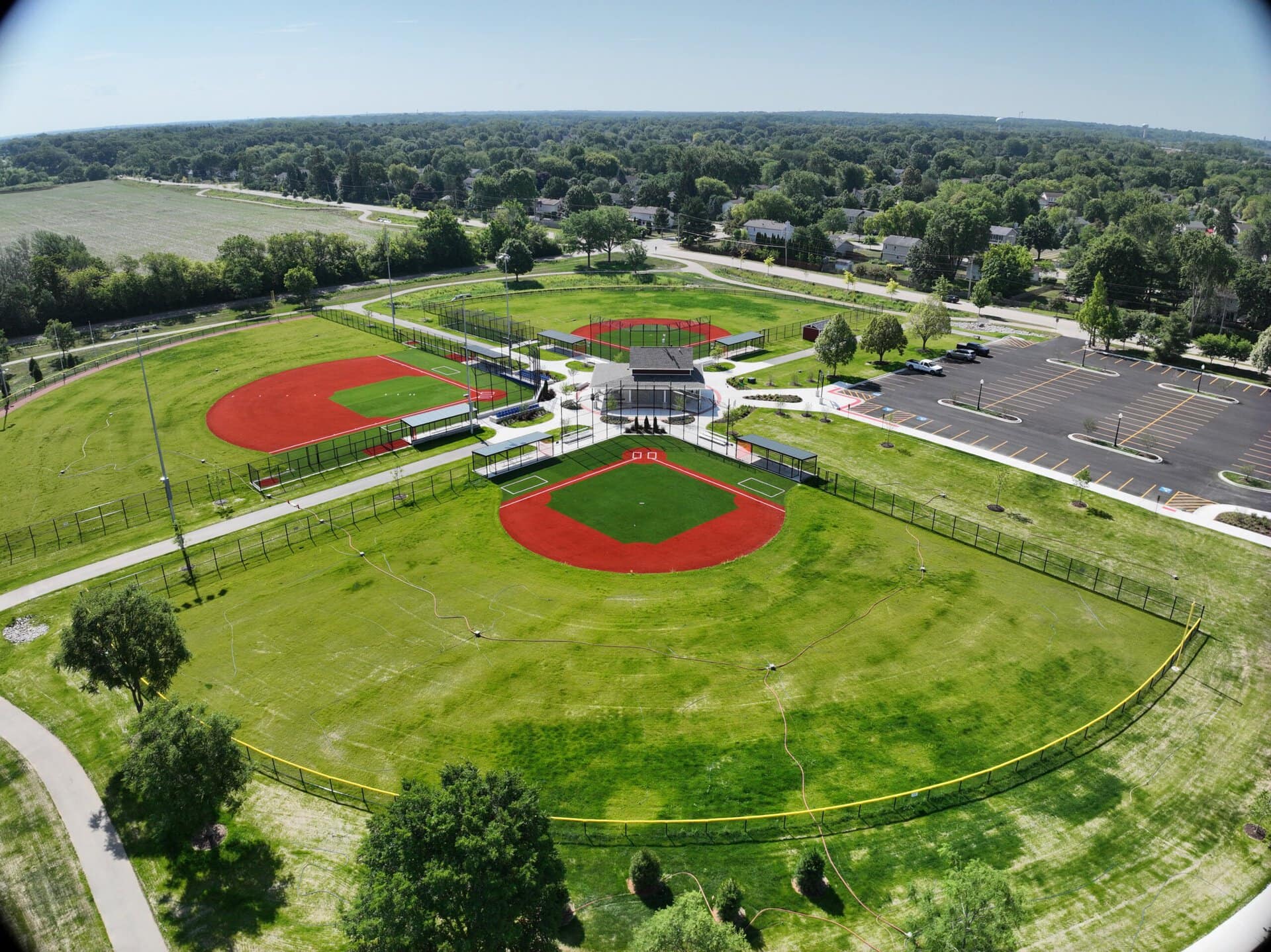 Community baseball field with well-maintained grass and facilities.